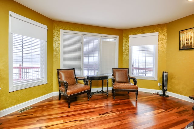 sitting room featuring a wealth of natural light and hardwood / wood-style floors