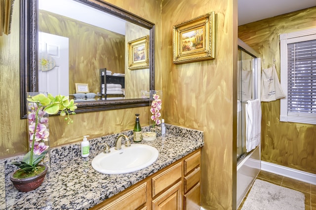 bathroom with bath / shower combo with glass door, wooden walls, tile patterned floors, and vanity