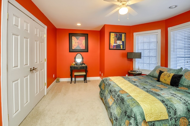 carpeted bedroom with a closet and ceiling fan