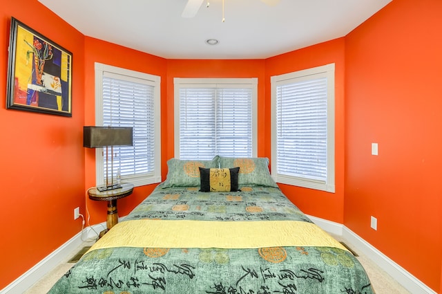 carpeted bedroom with ceiling fan