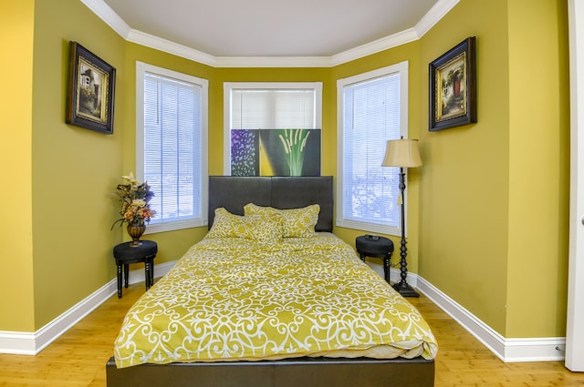 bedroom featuring light wood-type flooring and crown molding