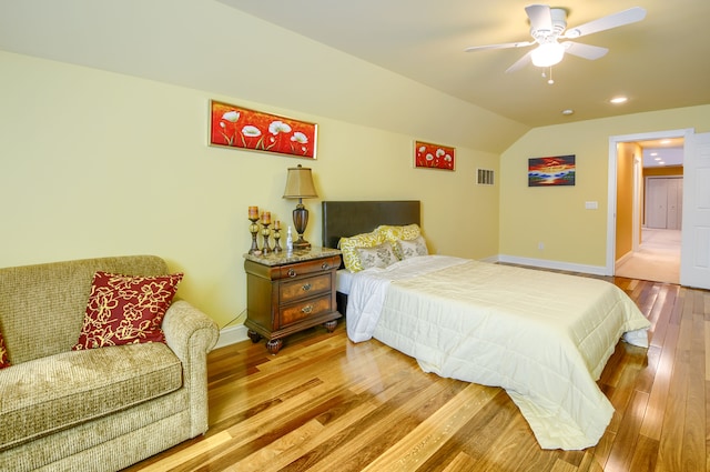 bedroom featuring ceiling fan, lofted ceiling, and wood-type flooring