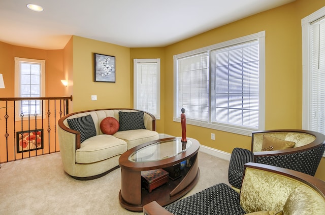 sitting room featuring a wealth of natural light and light colored carpet