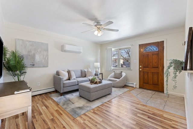 living room featuring a wall mounted air conditioner, light hardwood / wood-style floors, ceiling fan, and a baseboard heating unit