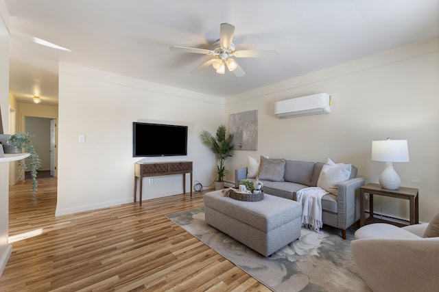 living room with hardwood / wood-style floors, a wall mounted AC, and ceiling fan