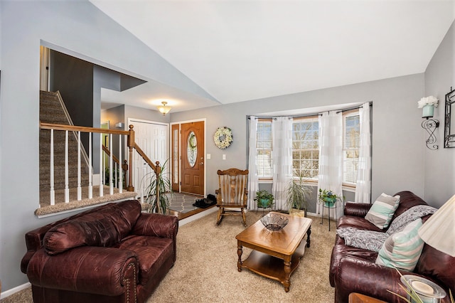 living room featuring carpet floors and vaulted ceiling