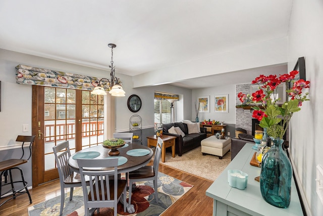 dining room with hardwood / wood-style floors and a chandelier