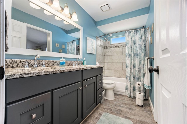 full bathroom featuring shower / bathtub combination with curtain, vanity, and toilet