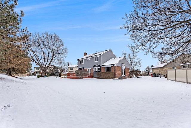 view of snow covered rear of property