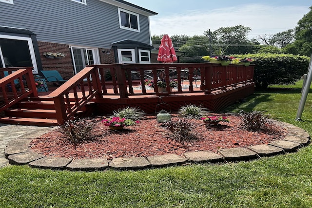 wooden deck with a lawn