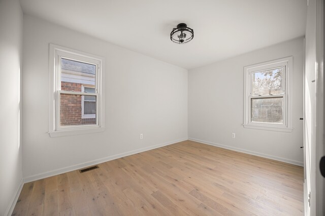 empty room with light hardwood / wood-style flooring