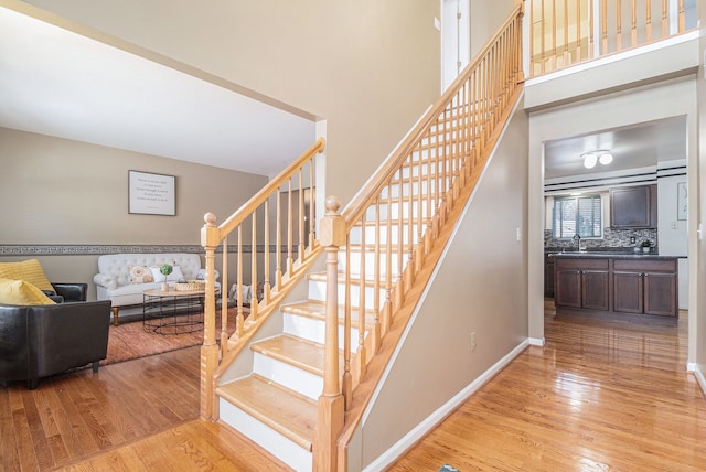 stairway featuring sink and hardwood / wood-style flooring