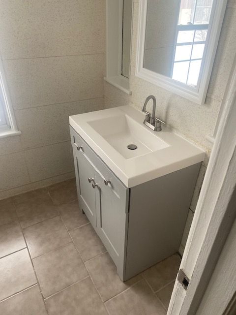 bathroom featuring tile patterned flooring and vanity