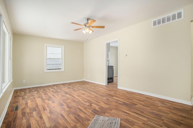 spare room with ceiling fan and dark hardwood / wood-style floors