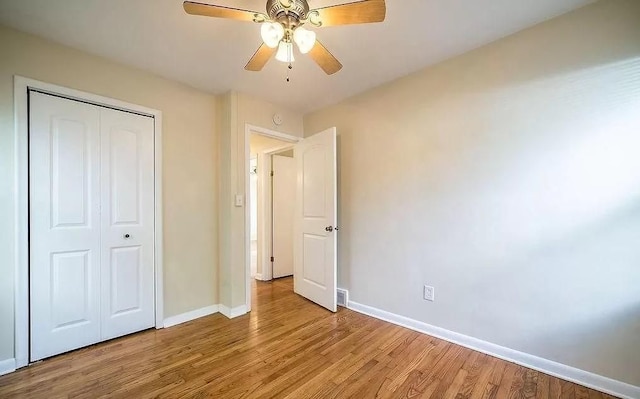 unfurnished bedroom with ceiling fan, light hardwood / wood-style floors, and a closet