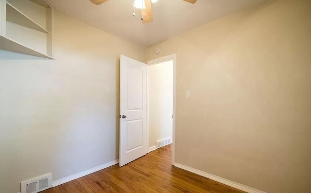 empty room with ceiling fan and hardwood / wood-style floors