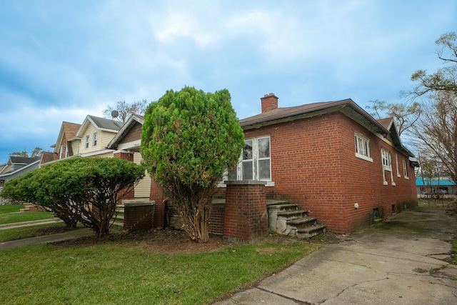 view of property exterior with a lawn