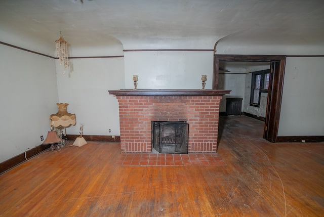 unfurnished living room with a fireplace and hardwood / wood-style flooring