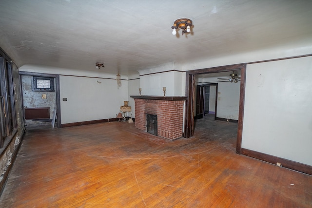 unfurnished living room with a fireplace and wood-type flooring