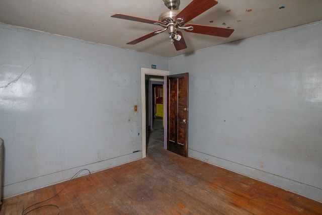 empty room with ceiling fan and hardwood / wood-style flooring