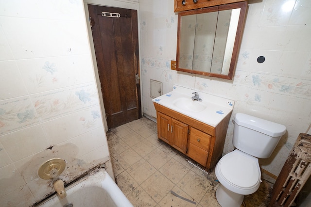 bathroom with a tub, vanity, and toilet