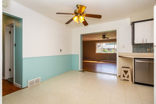 kitchen featuring white cabinets, decorative backsplash, ceiling fan, and dishwasher