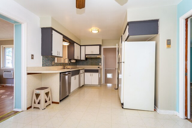 kitchen with white fridge, dishwasher, gray cabinets, sink, and backsplash