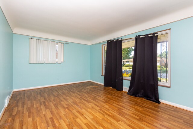 unfurnished room with hardwood / wood-style flooring