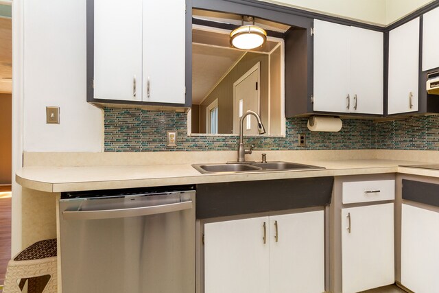 kitchen featuring white cabinets, dishwasher, decorative backsplash, and sink