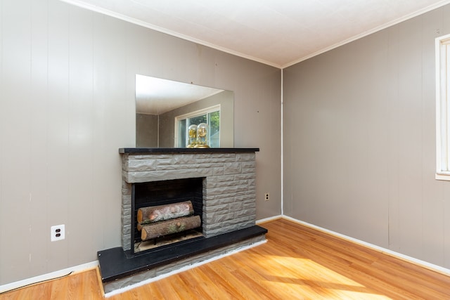 interior details featuring crown molding, a fireplace, and wood-type flooring