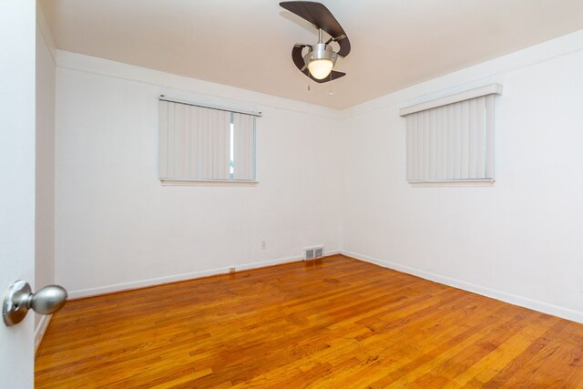 spare room featuring crown molding and wood-type flooring