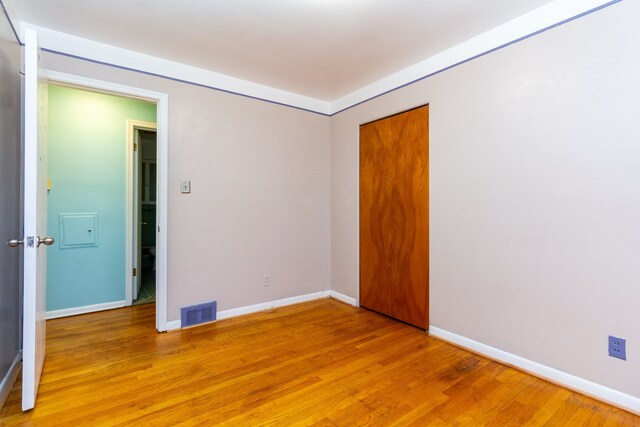 empty room with hardwood / wood-style floors