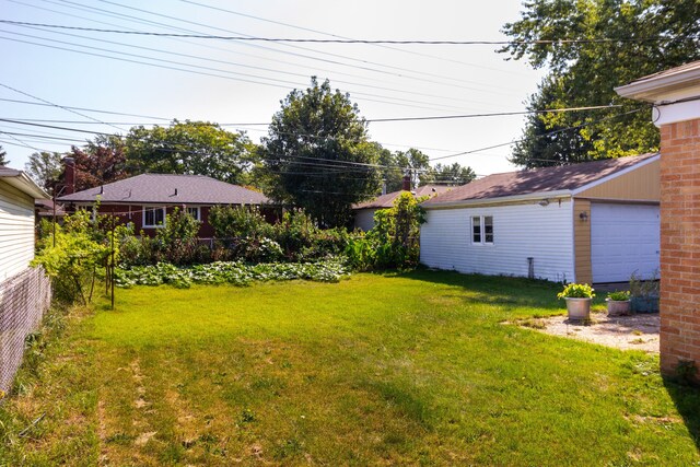 view of yard featuring an outbuilding and a garage