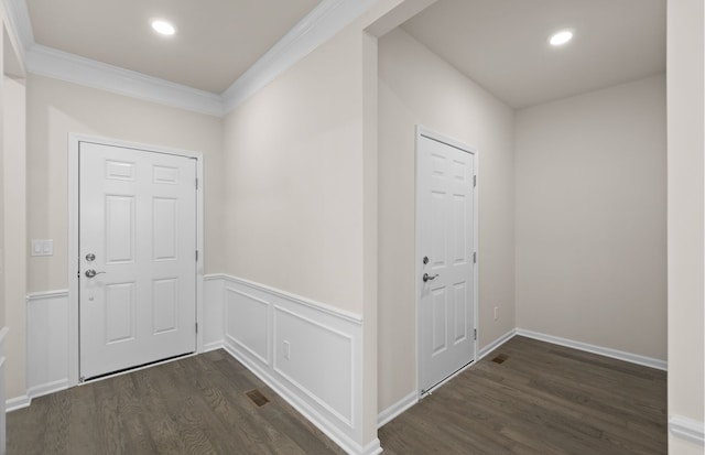 entrance foyer featuring wainscoting, ornamental molding, dark wood-type flooring, a decorative wall, and recessed lighting