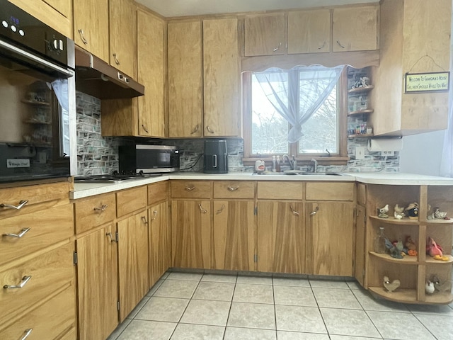 kitchen with sink, backsplash, light tile patterned flooring, and wall oven