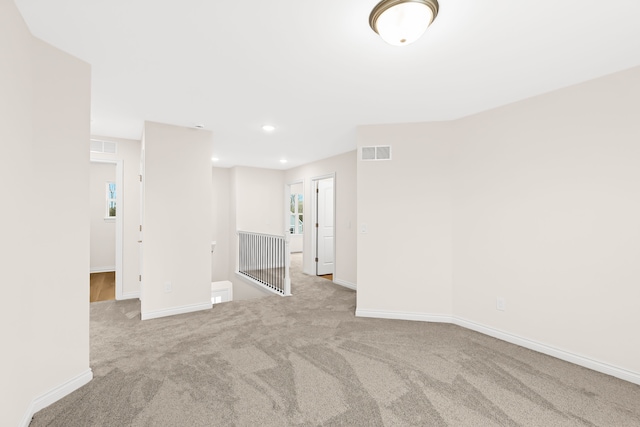 spare room featuring light colored carpet