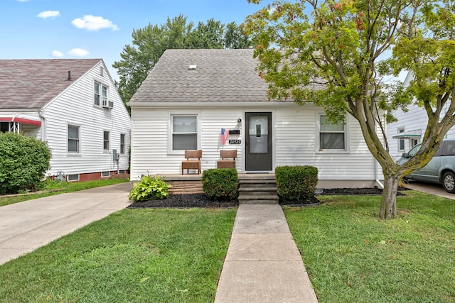 bungalow-style home with a front lawn