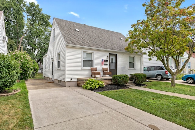 bungalow-style home featuring a front yard