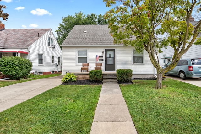 bungalow-style home with a front lawn