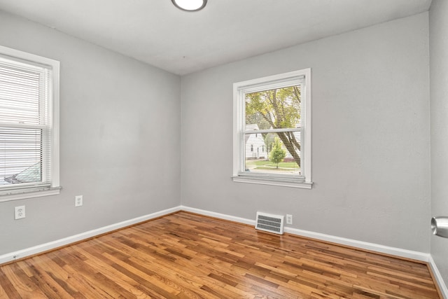 unfurnished room with hardwood / wood-style floors