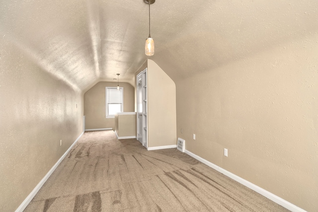 bonus room with a textured ceiling, vaulted ceiling, and carpet floors