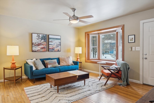 living room with ceiling fan and light hardwood / wood-style flooring