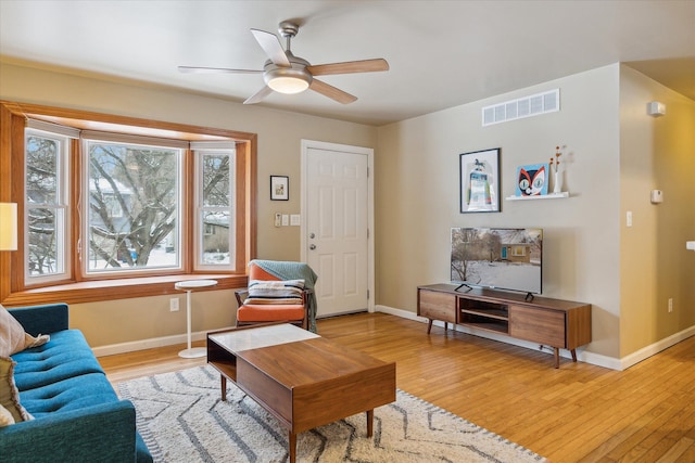 living room featuring ceiling fan and light hardwood / wood-style floors