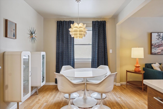 dining room featuring light hardwood / wood-style floors and a chandelier