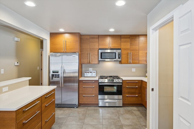 kitchen featuring stainless steel appliances and light tile patterned flooring