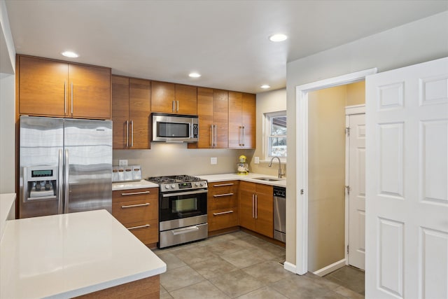 kitchen featuring sink, light tile patterned flooring, and appliances with stainless steel finishes