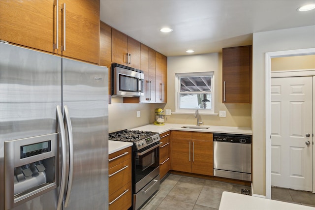 kitchen featuring appliances with stainless steel finishes, sink, and light tile patterned floors