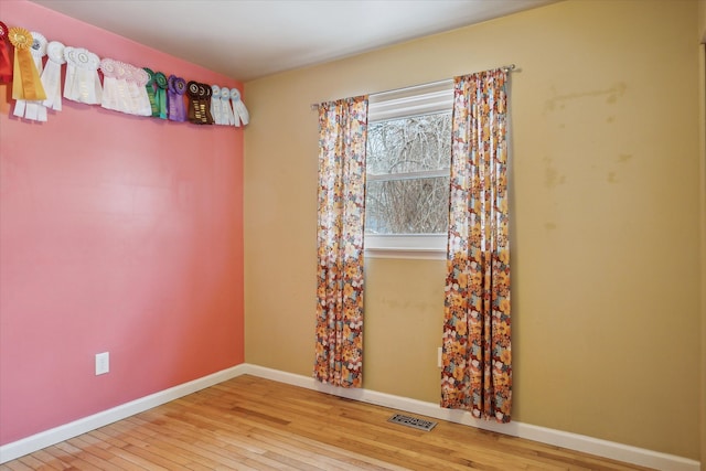 unfurnished room featuring hardwood / wood-style flooring