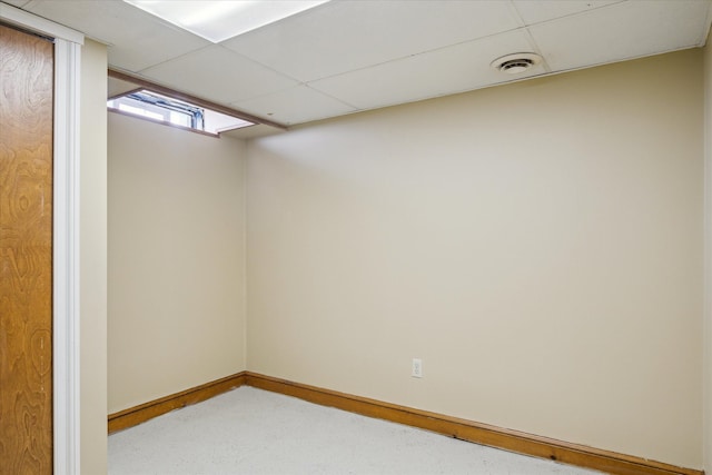 basement featuring a paneled ceiling