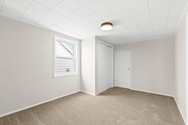 unfurnished bedroom featuring a closet and carpet flooring